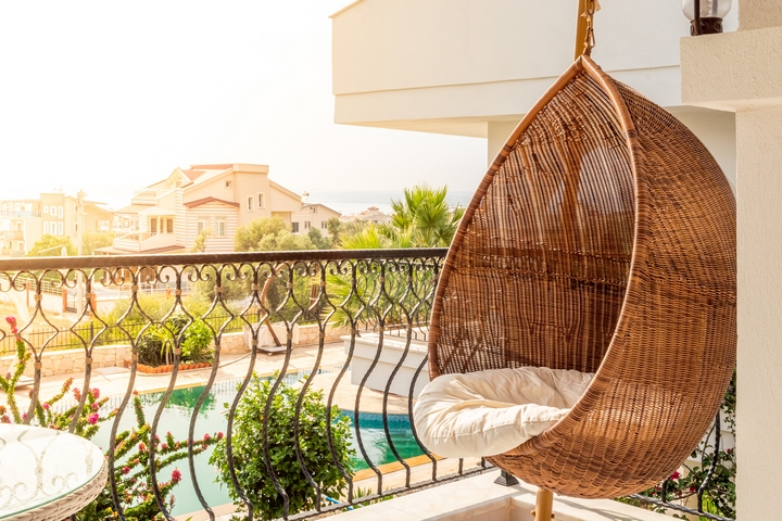 A swing seat can be a great idea for the condo balcony design.