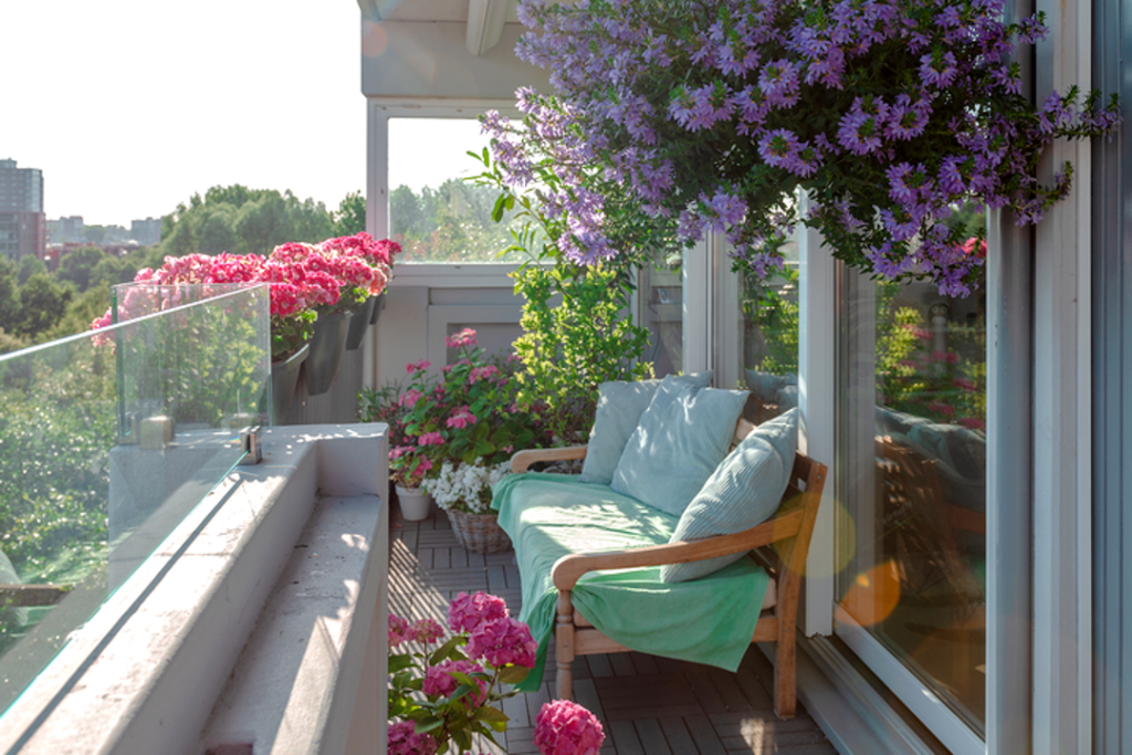 A good balcony lounge idea is to decorate it with flowers and plants.